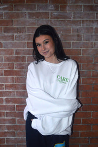 Founder in cozy white crew product.